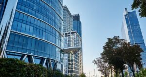 Insights 71 Modern glass office towers in a city under blue sky — business rates for offices in the UK