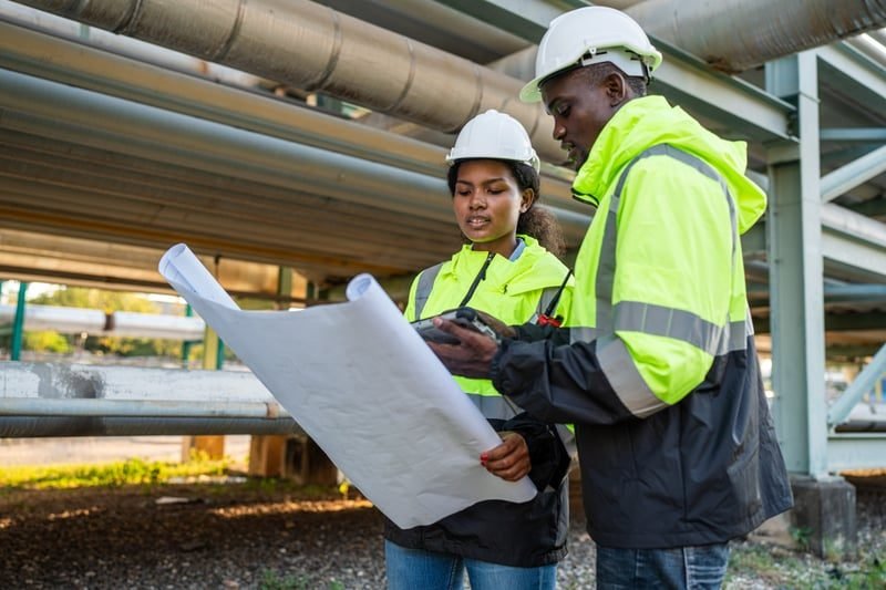 Construction Adjudication: A Complete UK Guide 4 Engineers reviewing construction contract documents and plans