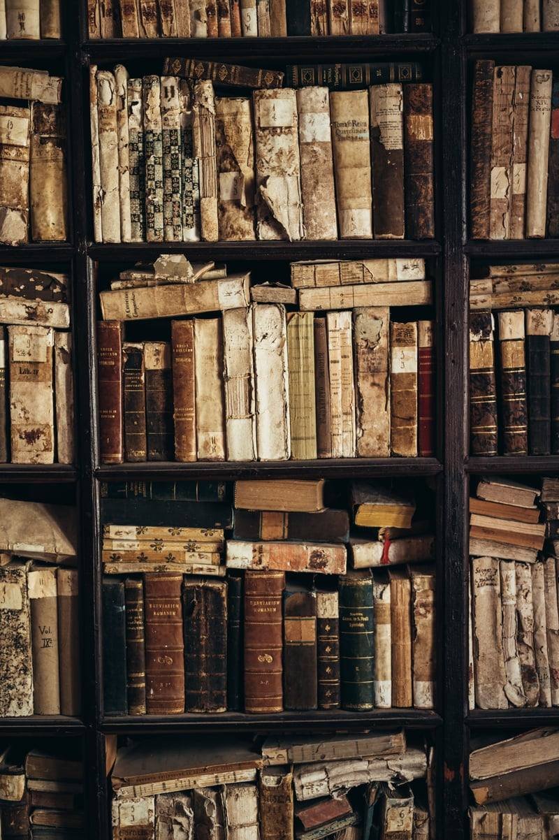 Old books on library shelves, representing copyright duration of life plus 70 years