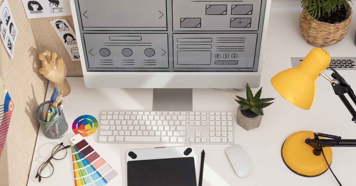Creative designer workspace with computer, colour swatches and design tools — copyright protection for UK businesses