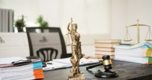Insights 66 Scales of justice and gavel on a lawyer's desk with legal documents — UK employment tribunals