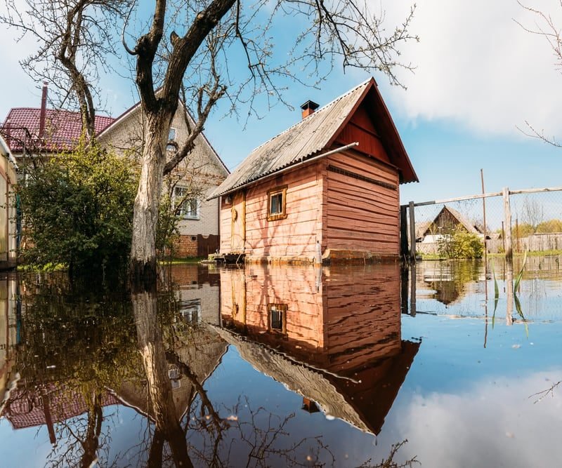 What Is an Environmental Search? A Plain-English Guide for UK Businesses 3 Flood water surrounding houses on a residential street, illustrating flood risk