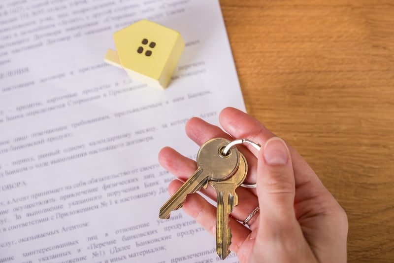 What Is an Environmental Search? A Plain-English Guide for UK Businesses 5 House keys on a mortgage agreement, showing how environmental risk affects lending and insurance