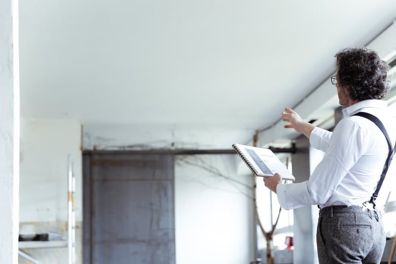 What Is an Environmental Search? A Plain-English Guide for UK Businesses 1 Home inspector examining a residential property during conveyancing due diligence