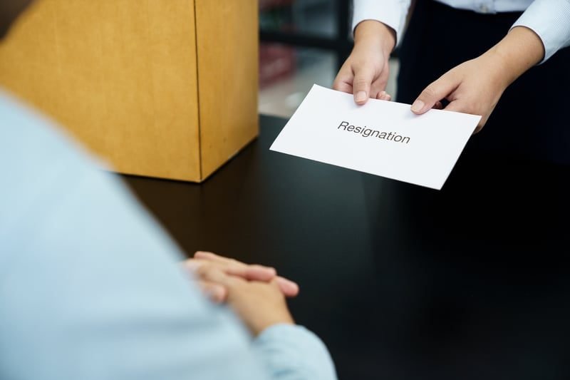 An employee handing in a resignation after an unresolved grievance
