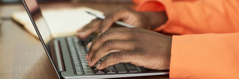 An employee putting a grievance in writing on a laptop