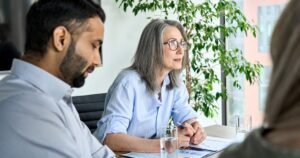 Insights 66 Two HR professionals attentively listening to an employee at a workplace meeting — grievance procedures in the UK
