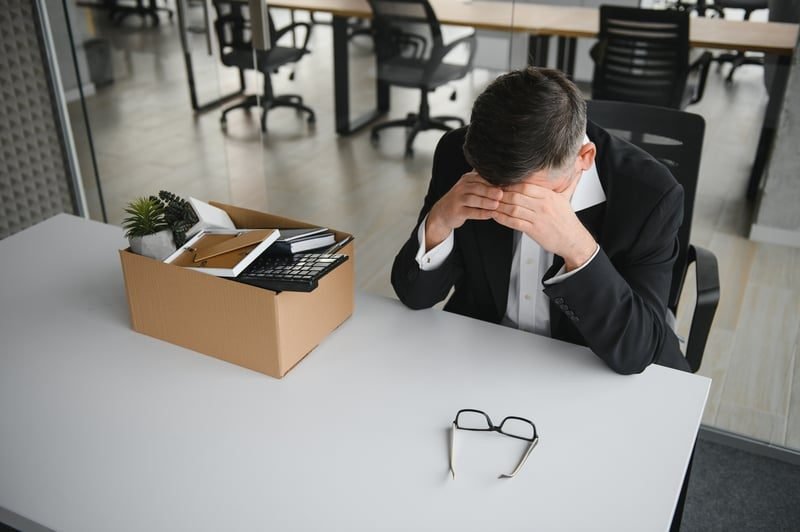 An unhappy employee raising a workplace grievance at their desk