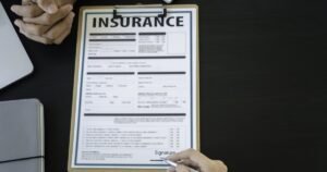 Insights 51 Two professionals reviewing an insurance claim form at a desk — UK insurance claims handling