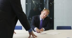 Insights 52 Two professionals reviewing documents in a dispute meeting at a modern office — UK insurance liability disputes