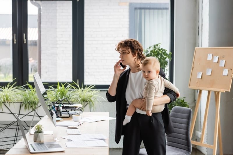 A mother returning to work in the office after maternity leave