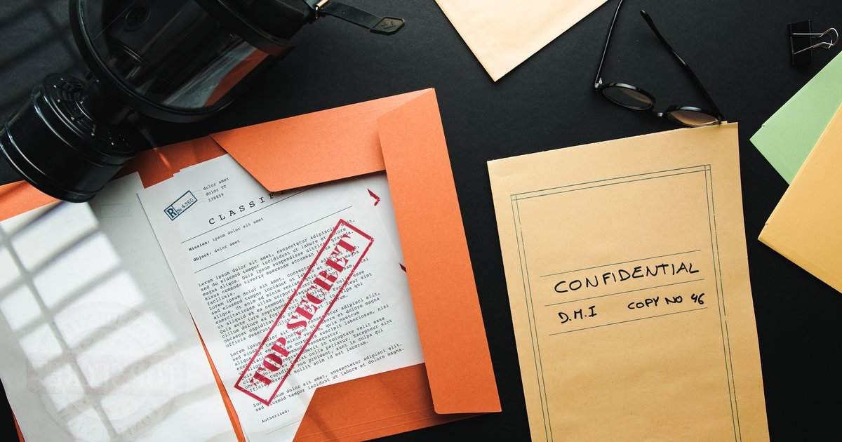 Confidential and top secret document folders on a dark desk — one-way vs mutual NDAs for London businesses