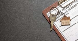 News 2 House keys with a house-shaped keychain resting on a rental tenancy agreement, illustrating the UK Renters Rights Act