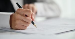Insights 60 Close-up of a professional signing a contract with a pen — restrictive covenants in UK employment