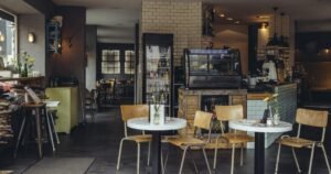 Insights 75 Interior of a bright, cosy cafe with tables and a counter — retail, hospitality and leisure relief in the UK