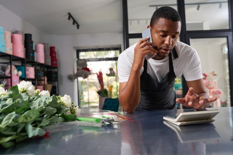 Business Rates for Retail Premises: A Complete UK Guide 4 Shop owner reviewing accounts to reduce a retail business rates bill