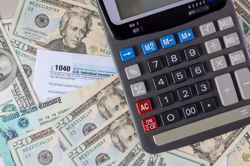 Strategic Property Reorganisation in London: What Local Businesses Need to Know 3 Calculator and money illustrating the SDLT charge on property transfers