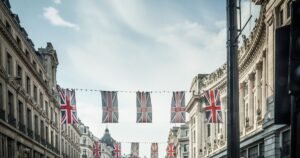 Insights 69 British high street with Union Jack bunting and shops on a sunny day — UK transitional rate relief for business premises