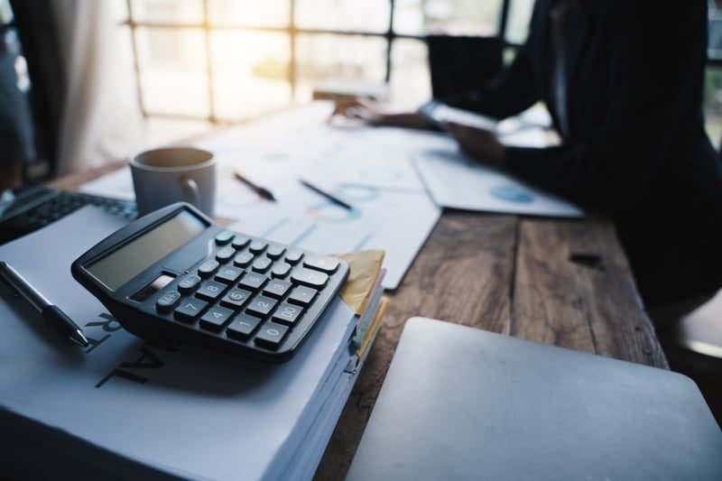 Business owner reviewing accounts to plan cash flow around phased rates increases