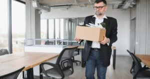 Insights 76 Employee carrying a cardboard box of belongings out of an office — unfair dismissal in the UK